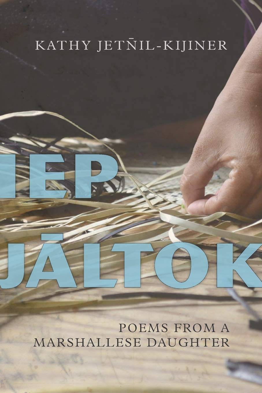 "Iep J&#257;ltok" book cover featuring a zoomed in photo of a hand weaving grass.